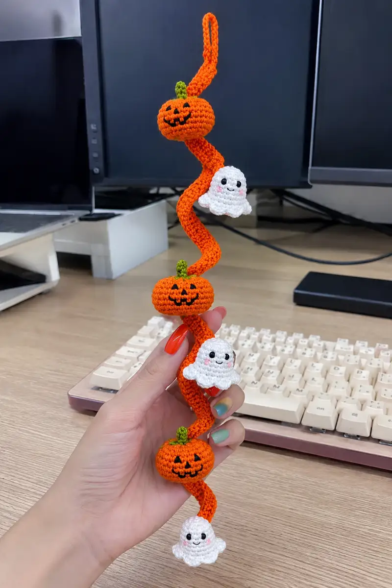 Orange Spiral Halloween Garland with Cute Ghosts and Pumpkins Pattern crochet pattern - detailed view of completed project